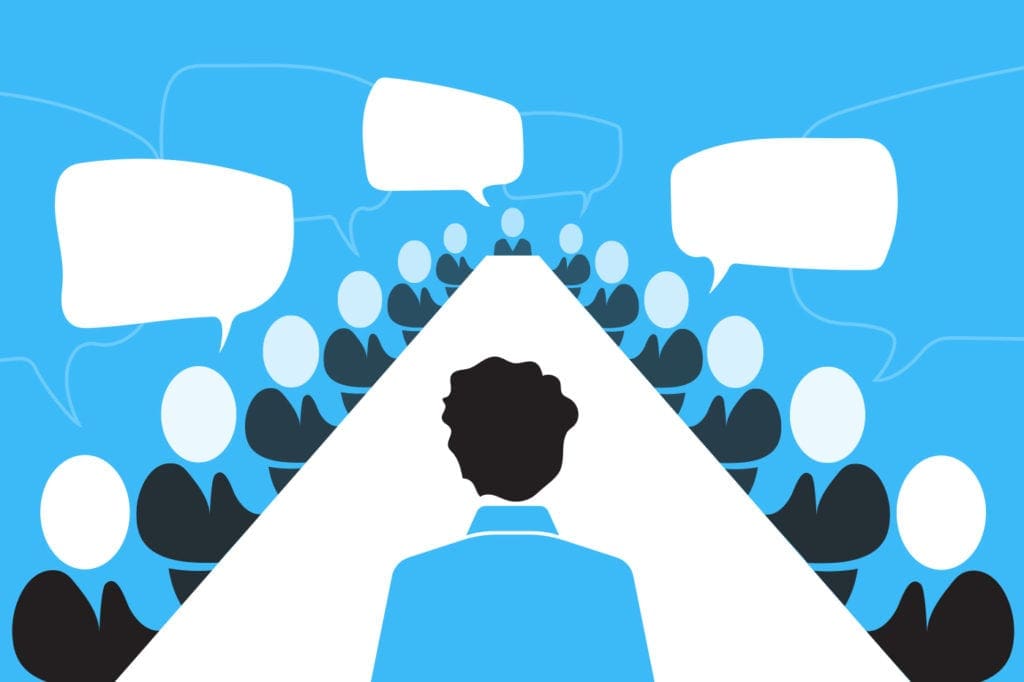 Illustration of death by committee with speaker at a giant boardroom table