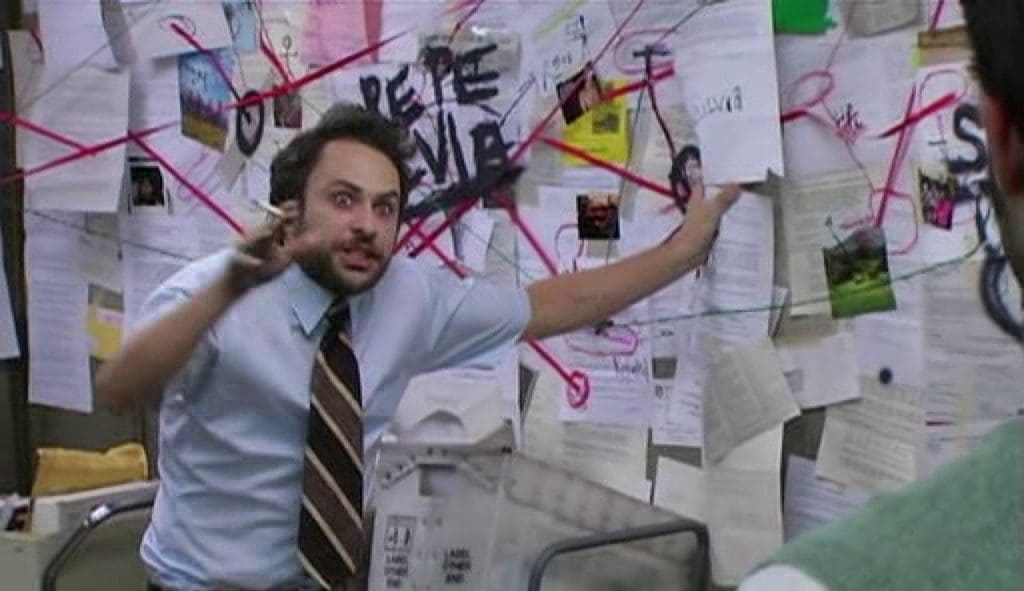 Charlies from It's Always Sunny in Philadelphia standing in front of a conspiracy map.