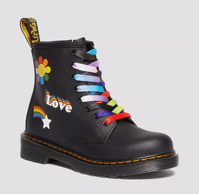 Doc Martens shoe with pride stickers and rainbow laces