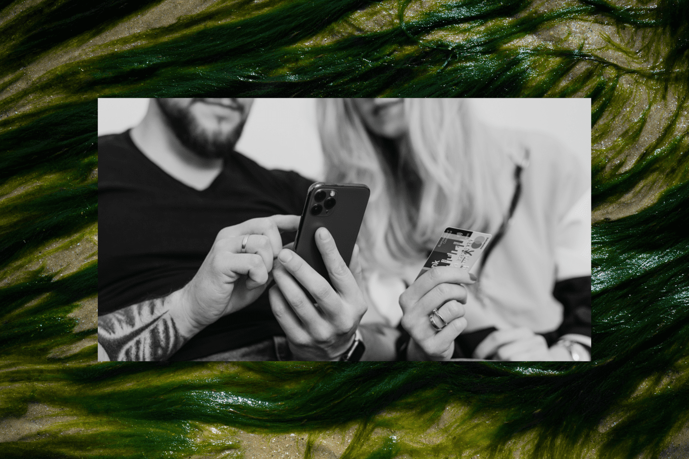 Close-up of two people using a smartphone and credit card to make an online donation, representing nonprofit fundraising platforms and digital giving tools.