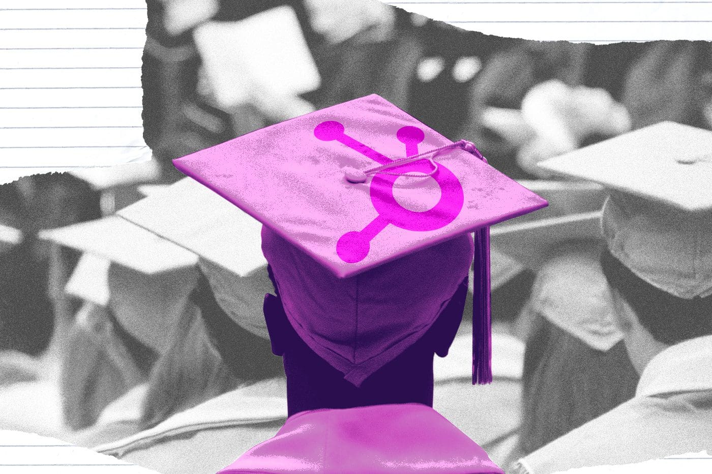 A graduate wearing a purple cap with the HubSpot logo, symbolizing the integration of HubSpot tools in higher education settings like colleges and universities. Other graduates in caps and gowns are visible in the background.