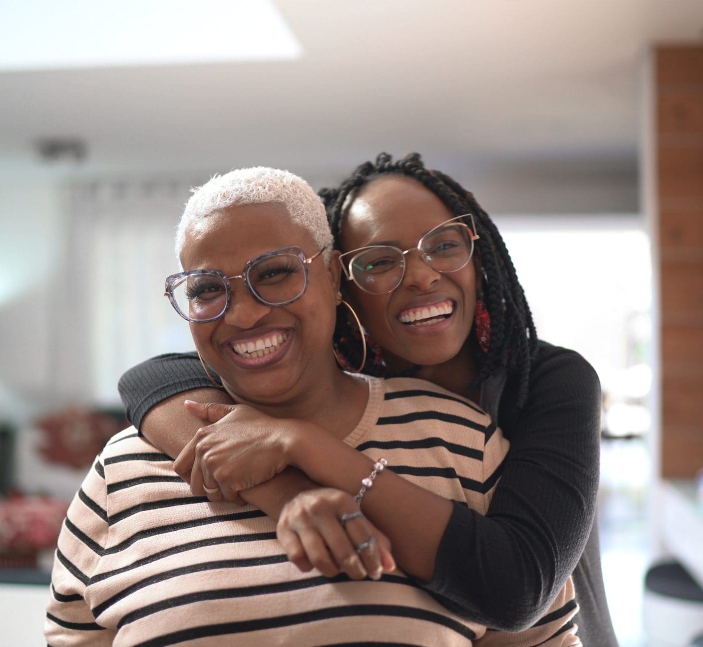 Adult daughter hugging her elderly mom