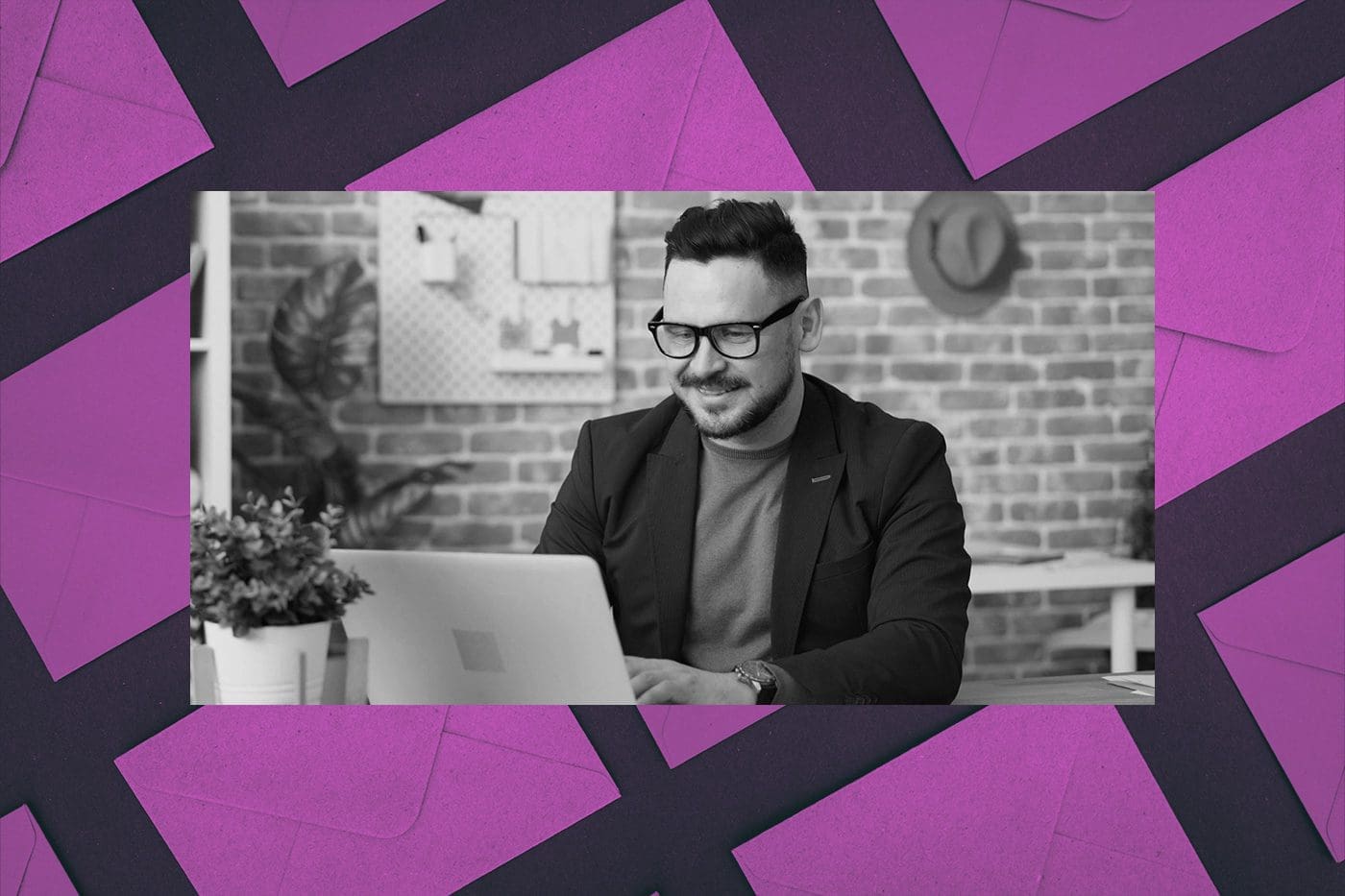 Black-and-white photo of a man wearing glasses and a blazer, smiling while working on a laptop in a modern office. The image is framed by a colorful background of overlapping purple envelopes, suggesting themes of email marketing and relationship building.