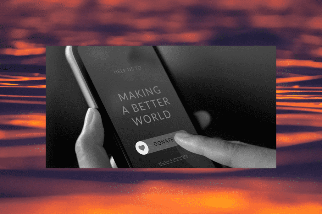 Close-up of a person tapping a “donate” button on a smartphone screen reading “making a better world,” representing digital giving and donor engagement strategies for nonprofits.