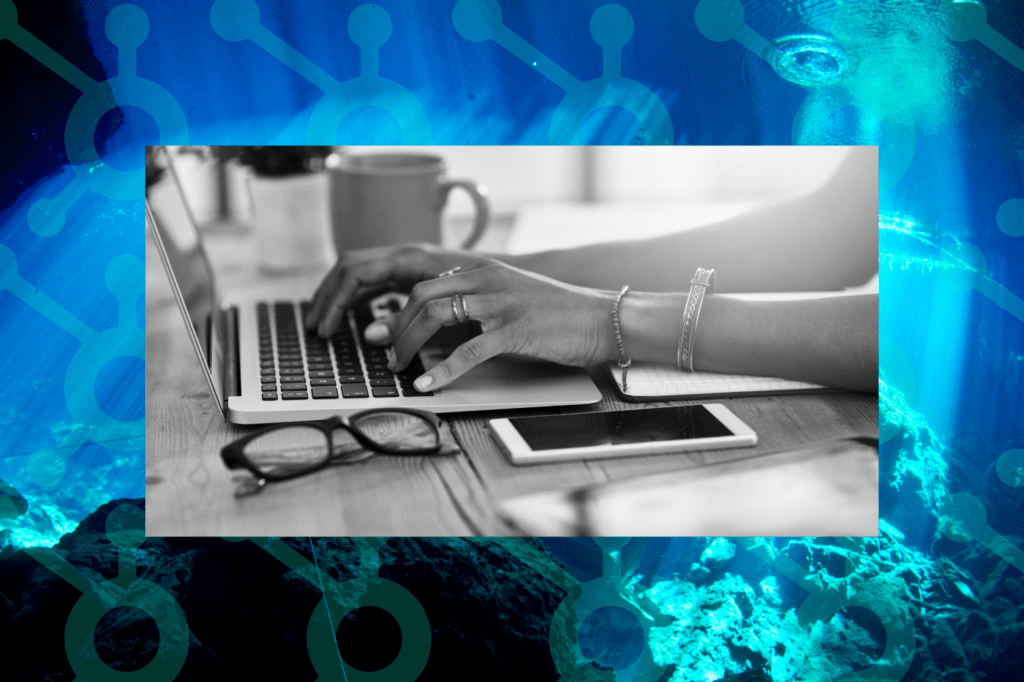 Woman working with the HubSpot CRM platform on her laptop.