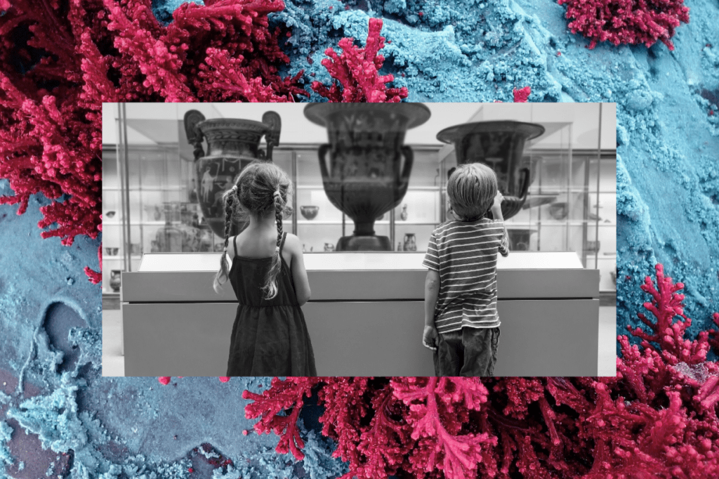 Two young children looking at three ancient vases behind glass at a museum.
