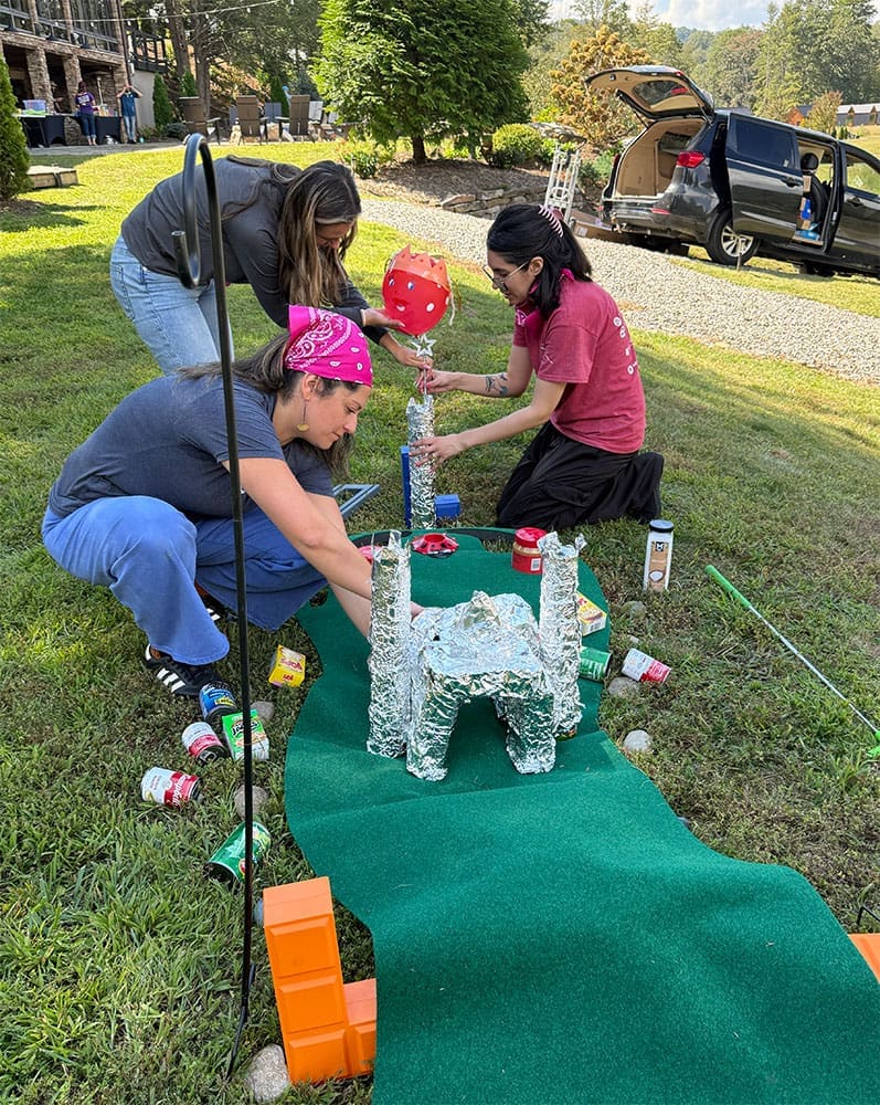 Big Sea team members constructing a putt putt hole as part of MANNA Food Bank volunteer activity.